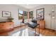 Bright home office with natural light from multiple windows, and simple furniture on a stylish rug at 31402 N Bermuda Dunes Dr, Evergreen, CO 80439
