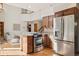 Bright kitchen features stainless appliances, wood cabinets and a cooktop island at 31402 N Bermuda Dunes Dr, Evergreen, CO 80439