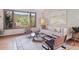 Cozy living room with large windows offering scenic views and an inviting seating area at 31402 N Bermuda Dunes Dr, Evergreen, CO 80439