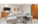 Cozy living room featuring plush sectional sofa, soft natural light, and inviting decor at 31402 N Bermuda Dunes Dr, Evergreen, CO 80439