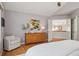 Spacious main bedroom with a large dresser, sitting chair, and a view to a balcony at 31402 N Bermuda Dunes Dr, Evergreen, CO 80439
