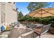 Cozy outdoor patio featuring comfortable seating and an umbrella, perfect for relaxing and entertaining at 31402 N Bermuda Dunes Dr, Evergreen, CO 80439