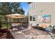 Outdoor patio with seating, mature trees, and sunny backyard at 31402 N Bermuda Dunes Dr, Evergreen, CO 80439