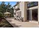 Outdoor patio with stone pavers, seating, and sunny backyard at 31402 N Bermuda Dunes Dr, Evergreen, CO 80439