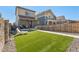 This backyard features lawn and gravel area, with new construction homes in the area at 12794 Tamarac St, Thornton, CO 80602