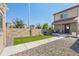 Fenced backyard area with lawn, a stone wall and gravel. Perfect place to relax! at 12794 Tamarac St, Thornton, CO 80602