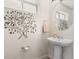 Half bath with pedestal sink and stylish wall art at 12794 Tamarac St, Thornton, CO 80602