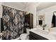 Stylish bathroom with decorative shower curtain, vanity and plenty of storage at 12794 Tamarac St, Thornton, CO 80602