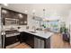 Modern kitchen with stainless steel appliances, an island, and an open floor plan at 12794 Tamarac St, Thornton, CO 80602