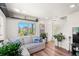 Bright living area with large windows, hardwood floors, and comfortable seating at 12794 Tamarac St, Thornton, CO 80602