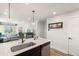 Bright living room with hardwood floors and neutral decor open to kitchen at 12794 Tamarac St, Thornton, CO 80602
