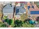 Aerial view of home shows solar panels, a pool, and a well-kept lawn at 10908 Oakshire Ave, Highlands Ranch, CO 80126