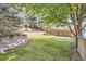 Landscaped backyard featuring a retaining wall with stone steps leading to a lawn at 10908 Oakshire Ave, Highlands Ranch, CO 80126