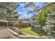 A nicely landscaped backyard featuring a retaining wall and view of home at 10908 Oakshire Ave, Highlands Ranch, CO 80126