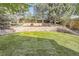 A beautifully landscaped backyard with a tiered stone retaining wall and a lush green lawn at 10908 Oakshire Ave, Highlands Ranch, CO 80126