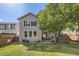 Landscaped backyard features a hot tub, lawn, and patio with seating area at 10908 Oakshire Ave, Highlands Ranch, CO 80126