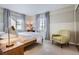 Bright bedroom with a comfortable sitting area and carpeted floors at 10908 Oakshire Ave, Highlands Ranch, CO 80126
