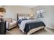 Cozy bedroom featuring a tufted headboard and large window at 10908 Oakshire Ave, Highlands Ranch, CO 80126