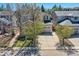 Traditional two-story home with a well-maintained lawn and long driveway at 10908 Oakshire Ave, Highlands Ranch, CO 80126