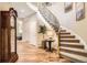 Grand foyer with a curved staircase and elegant lighting at 10908 Oakshire Ave, Highlands Ranch, CO 80126