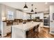 Bright, modern kitchen with quartz countertops, stainless appliances and wooden floors at 10908 Oakshire Ave, Highlands Ranch, CO 80126