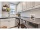 Well-equipped laundry room with modern washer and dryer, storage cabinets and a sink at 10908 Oakshire Ave, Highlands Ranch, CO 80126