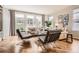 Cozy living room featuring hardwood floors, a modern sofa, and an abundance of natural light at 10908 Oakshire Ave, Highlands Ranch, CO 80126