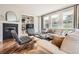 Comfortable living room features a fireplace, built-in shelves, and three large windows at 10908 Oakshire Ave, Highlands Ranch, CO 80126