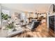 Open-concept living room with hardwood flooring, fireplace, and modern furniture at 10908 Oakshire Ave, Highlands Ranch, CO 80126