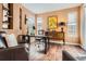 Inviting office space featuring hardwood floors, built-in shelving, and natural light from two windows at 10908 Oakshire Ave, Highlands Ranch, CO 80126