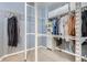 Organized walk-in closet with metal shelving and hanging clothes in a blue room at 10908 Oakshire Ave, Highlands Ranch, CO 80126
