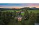 Aerial view of house surrounded by trees in a mountain setting at 31756 Buffalo Park Rd, Evergreen, CO 80439