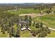 Aerial view of a house with outbuildings in a green, mountainous landscape at 31756 Buffalo Park Rd, Evergreen, CO 80439