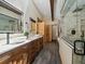 Bathroom with double sinks, vessel sinks, stone and wood accents, and glass enclosed shower at 31756 Buffalo Park Rd, Evergreen, CO 80439