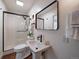 Modern bathroom with a pedestal sink, sleek black hardware, and a glass-enclosed shower at 31756 Buffalo Park Rd, Evergreen, CO 80439