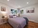 Serene bedroom featuring natural light, hardwood floors, and soothing decor elements at 31756 Buffalo Park Rd, Evergreen, CO 80439