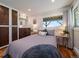 Comfortable bedroom with hardwood floors, a cozy bed, and stylish decor at 31756 Buffalo Park Rd, Evergreen, CO 80439