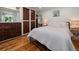 Bright bedroom with hardwood floors, a comfortable bed, and ample closet space at 31756 Buffalo Park Rd, Evergreen, CO 80439