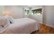 Cozy bedroom with hardwood floors, a comfortable bed, and bright natural light at 31756 Buffalo Park Rd, Evergreen, CO 80439