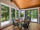 Bright breakfast nook with wood table, seating for four, views, and a wood ceiling at 31756 Buffalo Park Rd, Evergreen, CO 80439