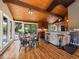 Cozy dining area featuring hardwood floors, access to the deck, and a breakfast bar at 31756 Buffalo Park Rd, Evergreen, CO 80439