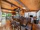 Large dining room with wood ceiling, hardwood floors, and a view of the patio at 31756 Buffalo Park Rd, Evergreen, CO 80439