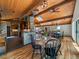 Bright dining room with wood floors, vaulted ceiling, skylight, and a view into the kitchen at 31756 Buffalo Park Rd, Evergreen, CO 80439