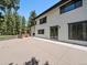 Exterior of home features a patio with an adjacent hot tub, perfect for entertaining at 31756 Buffalo Park Rd, Evergreen, CO 80439