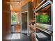Cozy kitchen featuring wood cabinetry, stone backsplash, granite counters, and stainless steel appliances at 31756 Buffalo Park Rd, Evergreen, CO 80439