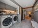Well-equipped laundry room with gray cabinets, a countertop, and a washer and dryer at 31756 Buffalo Park Rd, Evergreen, CO 80439