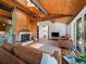 Inviting living room featuring vaulted wood ceilings, hardwood floors and a stone fireplace at 31756 Buffalo Park Rd, Evergreen, CO 80439