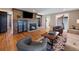 Inviting living room features a stone fireplace with wooden beam, hardwood floors, and modern furniture at 31756 Buffalo Park Rd, Evergreen, CO 80439