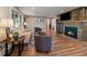 Cozy living room featuring a stone fireplace, hardwood floors, and comfortable seating at 31756 Buffalo Park Rd, Evergreen, CO 80439