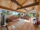 Spacious living room with wood ceiling, fireplace, hardwood floors, and sliding doors to deck at 31756 Buffalo Park Rd, Evergreen, CO 80439